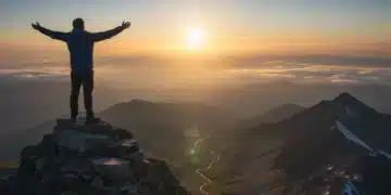 Person on mountaintop, symbolizing achieving achievable goals and personal success.